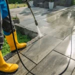 Une personne qui nettoie une terrasse en pierre